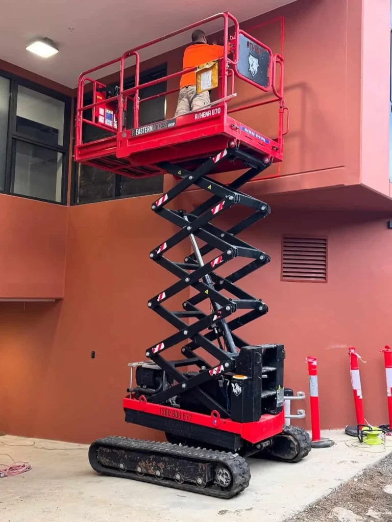 Almac Athena 870 BL EVO tracked scissor lift working on an outdoor site — view 2, available for hire from Equip Hire in Sydney.