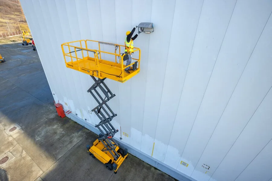 Haulotte Compact 12 electric scissor lift in use on an outdoor site, available for hire from Equip Hire in Sydney.