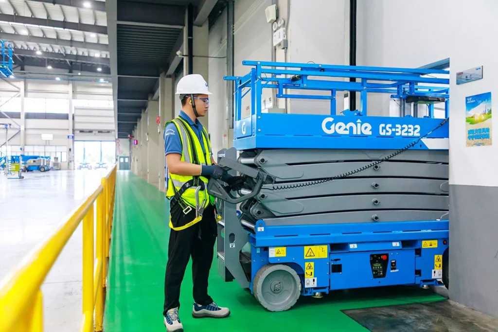 Genie GS-3232 narrow electric scissor lift working indoors on a finished floor, available for hire from Equip Hire in Sydney.